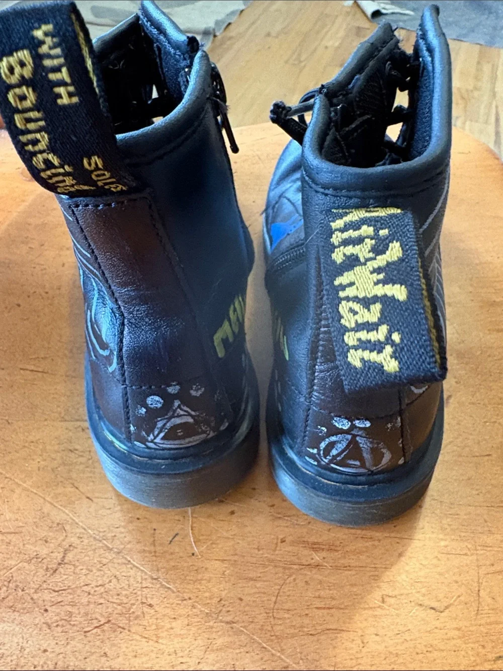 Dr. Martens Black Leather Unisex Kids Lace-Up Boots with Original Paint Artwork